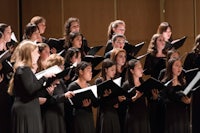 a group of women singing in a choir